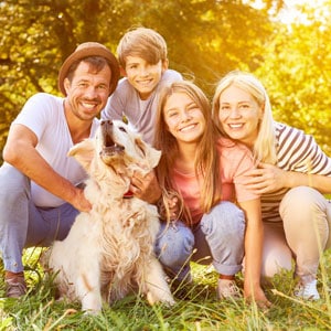 Image of a family with their dog, highlighting estate planning options for pet owners in Travis County