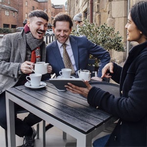 Lawyers discussing estate planning for same-sex couples over coffee.